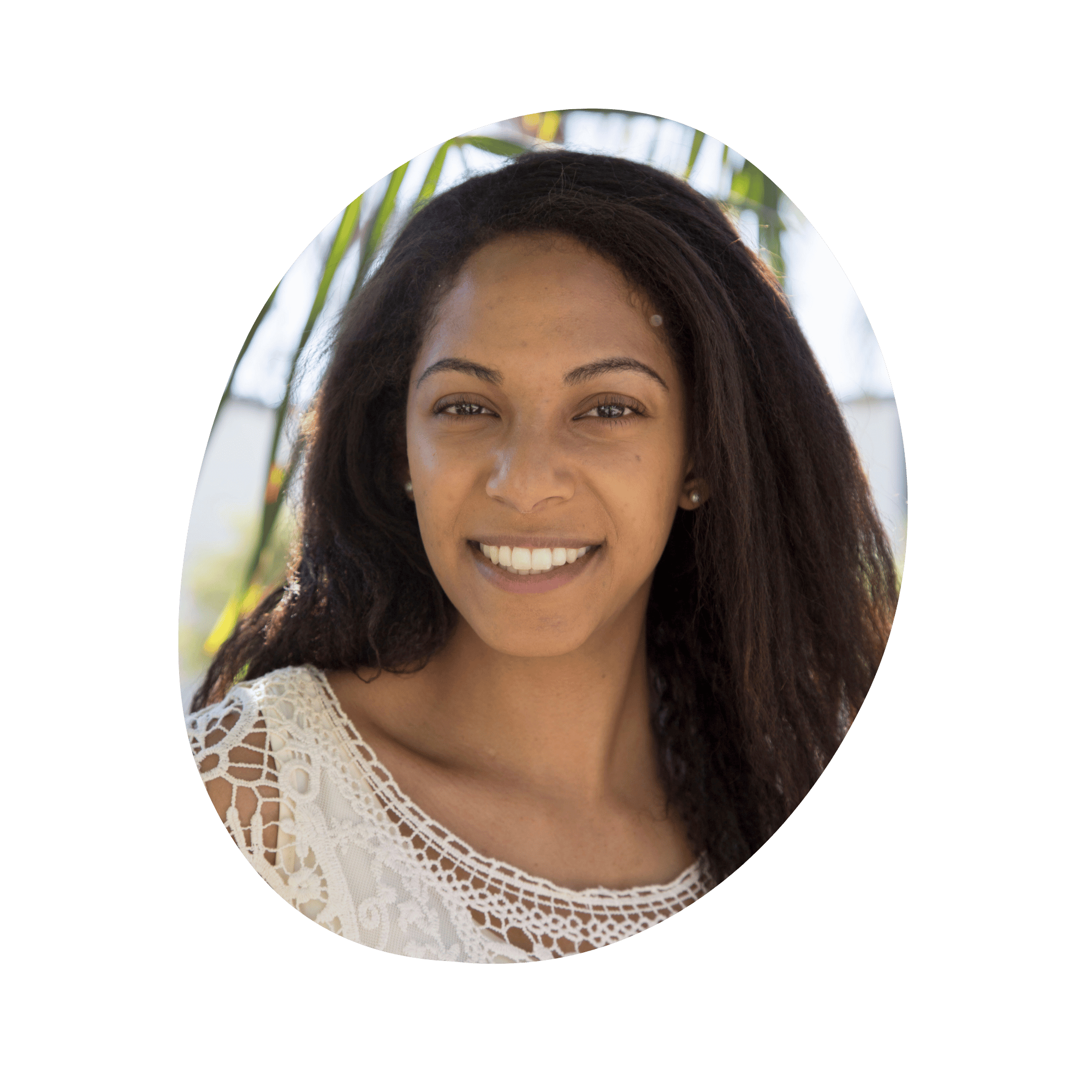 A headshot of a smiling woman with brown skin and brown hair.