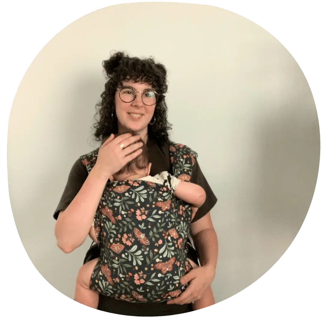 Woman babywearing her baby in a hope&plum lark