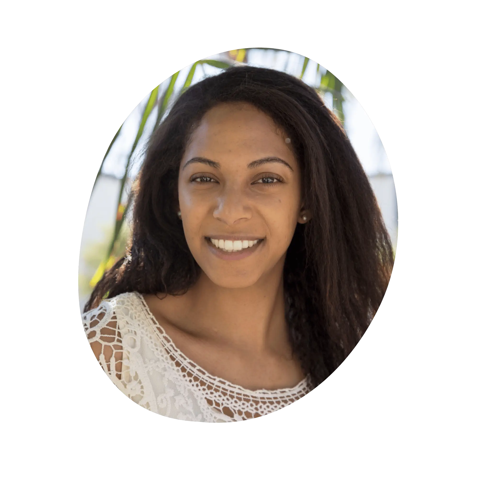 A headshot of a smiling woman with brown skin and brown hair.