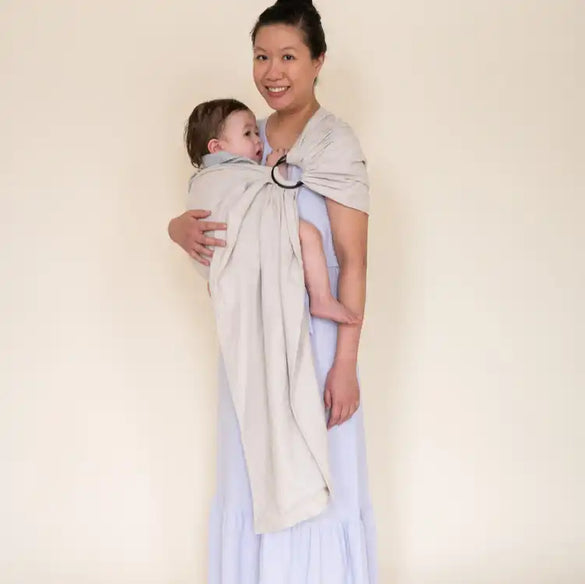 Asian mother wearing her baby in a gray ring sling baby carrier